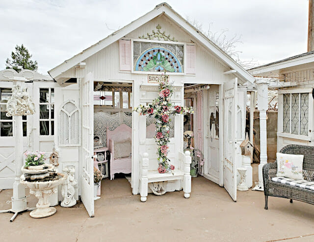 white prayer room with large floral cross outside