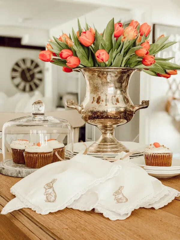 silver urn with orange tulips, cupcakes and bunny stamped napkins