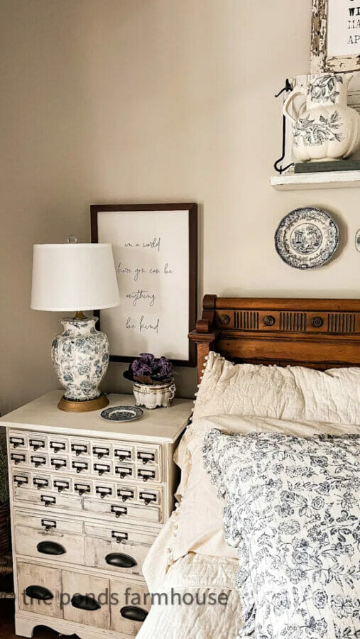 bedroom with side tble with blue and white decor