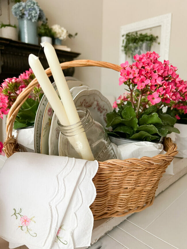 gift basket with plates, candles and potted flowers