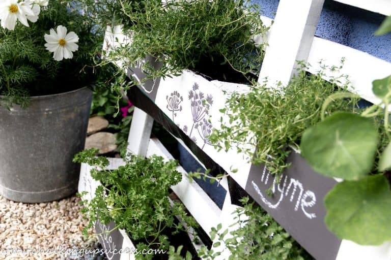 white pallet made into a gardening plant holder