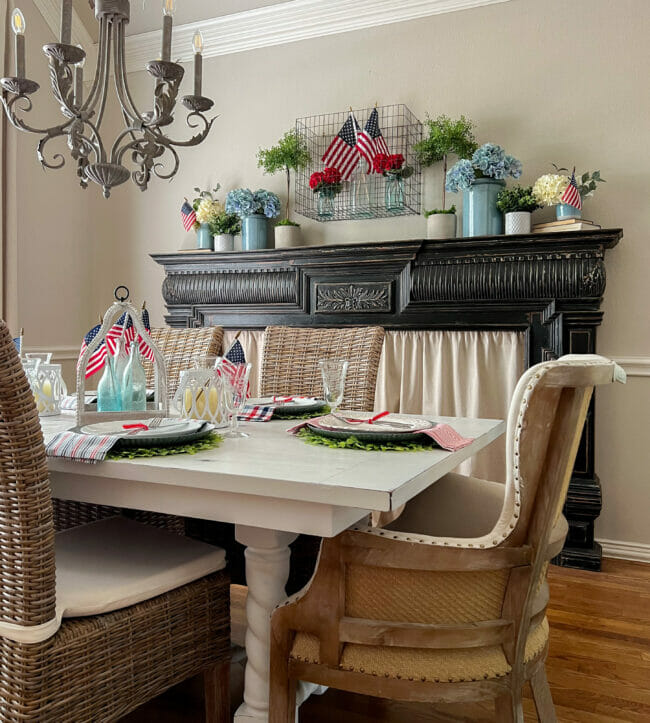 Patriotic decor in dining room with a black mantel and mini flags