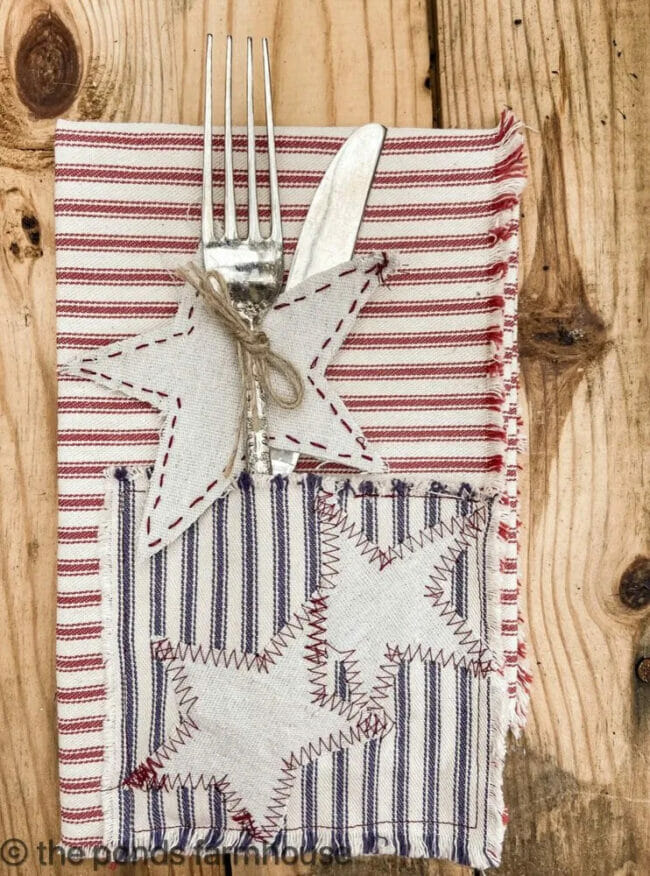 bed, white and blue striped utensil holder with fork and knife