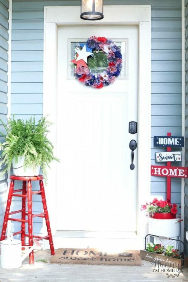 porch with red white and blue wreath and decor