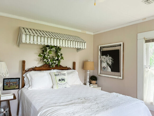 tin awning over bed with cow print on wall