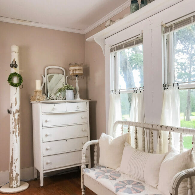 bed bench in front of windows, column and chest of drawers farmhouse style
