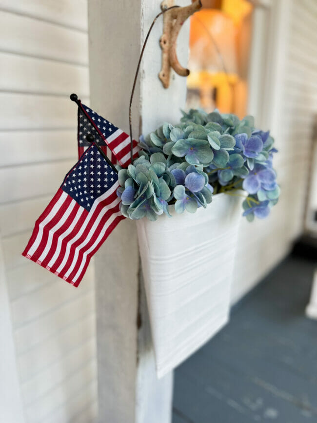 slim metal bucket with mini flags and blue hydrangeas