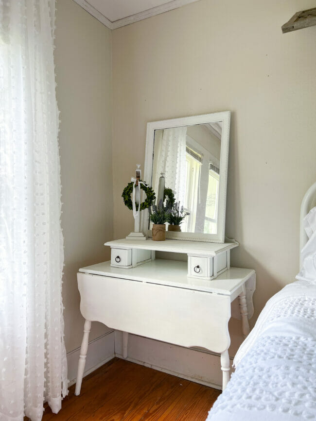 white flip table with sewing box and mirror on top for a countrified look