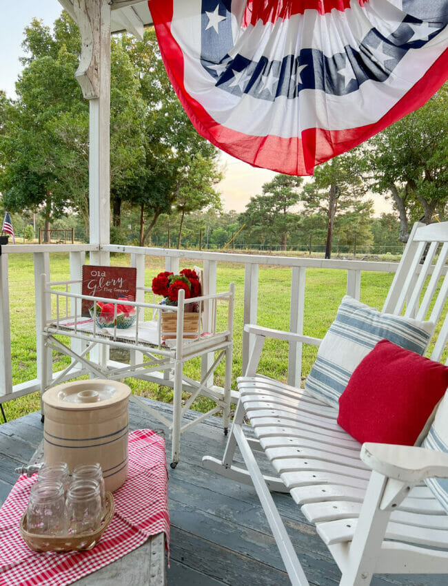 white rocker bench, babybed with flowers and watermelon, bunting and old crock with mason jars