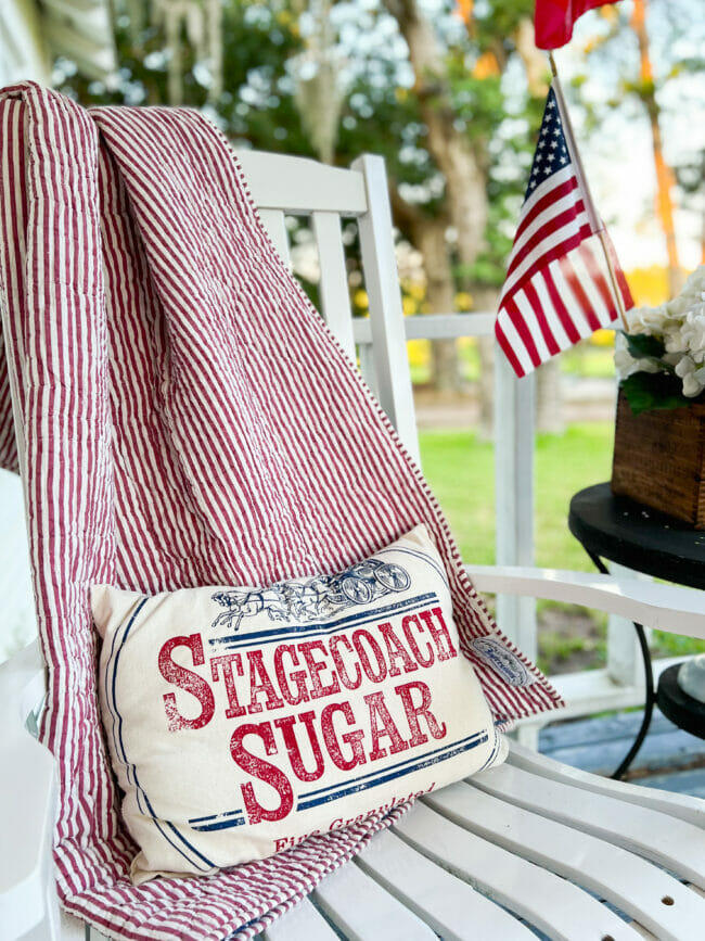 red striped blanket over rocking chair with Stagecoach Sugar pillow