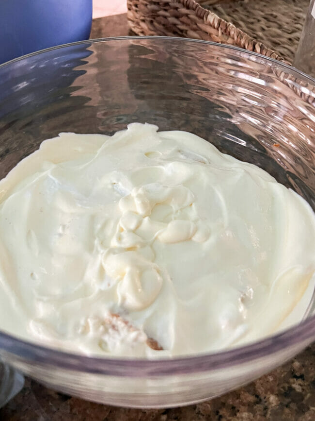 cool whip and pudding mixed sitting on cake pieces