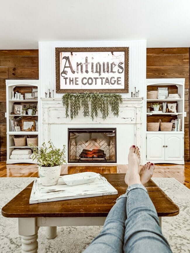 white mantel with bookshelves on either side.