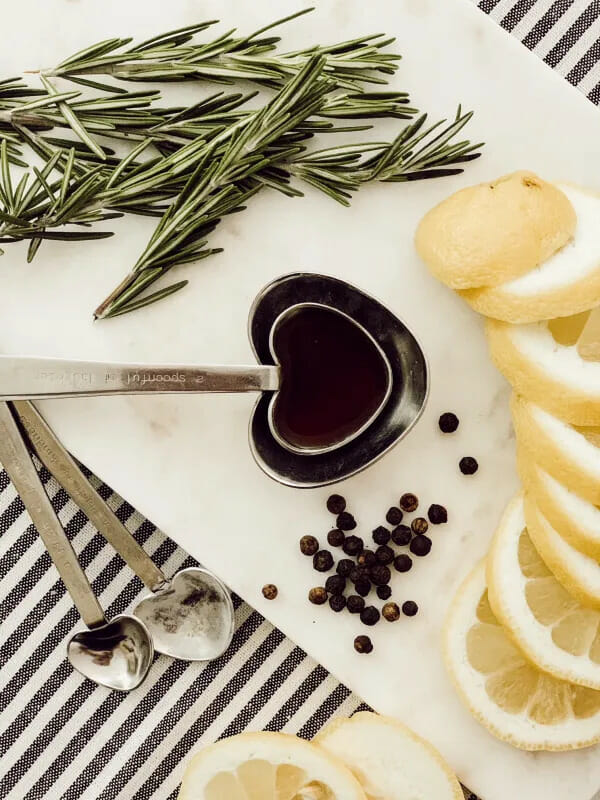 sliced lemons and herbs with a spoon