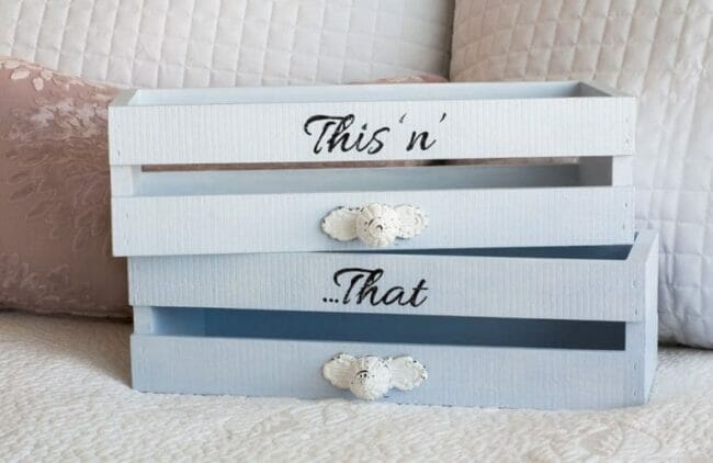 crate boxes with words and knobs sitting on sofa