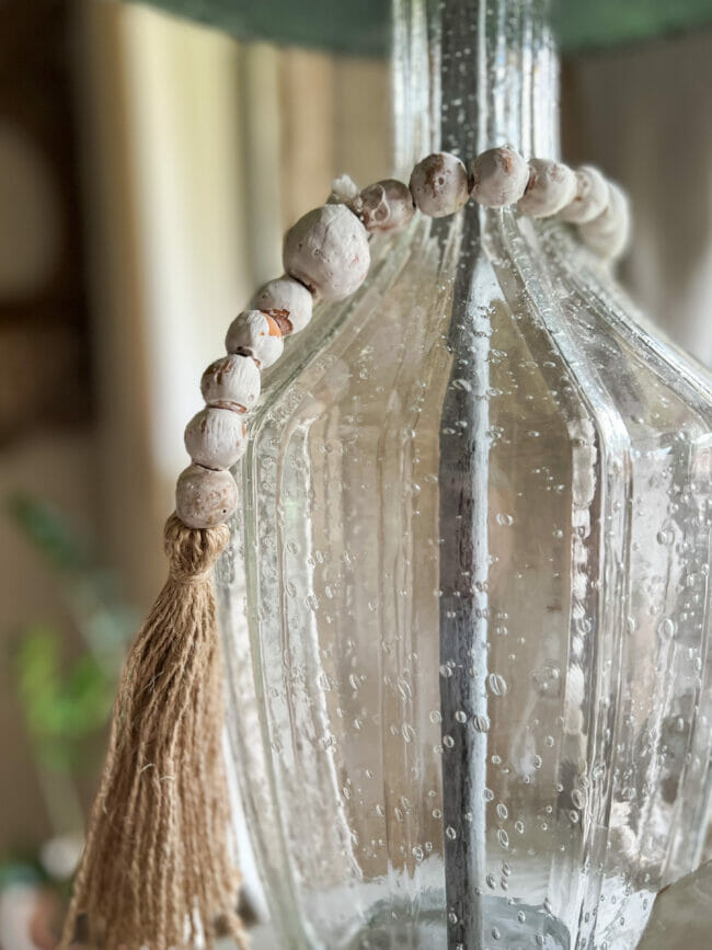 clear glass lamp with string of beads