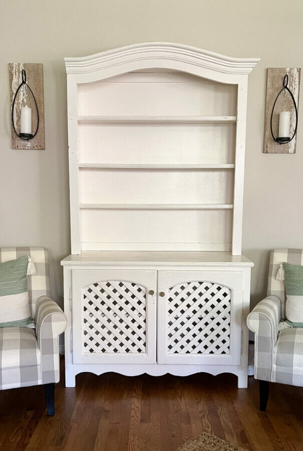 empty white vintage hutch with lattice doors