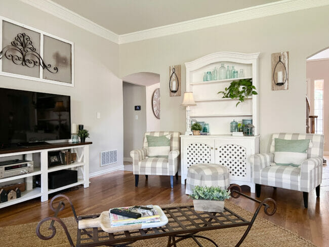 hutch with gray checked chairs, iron bench and TV