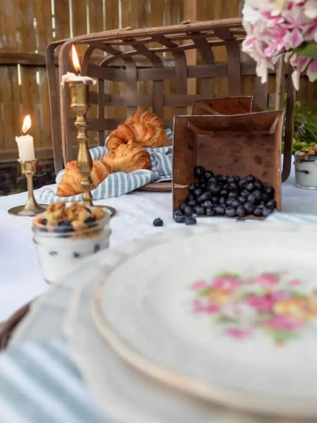 tablescape with croissants, berries and candles
