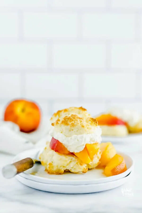 peaches with biscuit topping on white plate