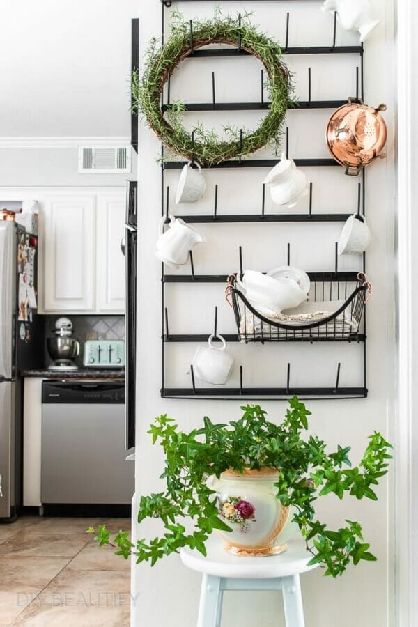 kitchen with wall cup holder, plant and herb wreath at top