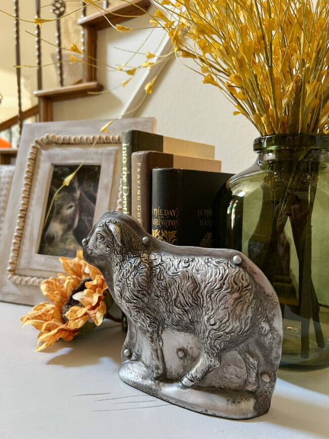 fall vignette with sheep mold, books and photo of donkey