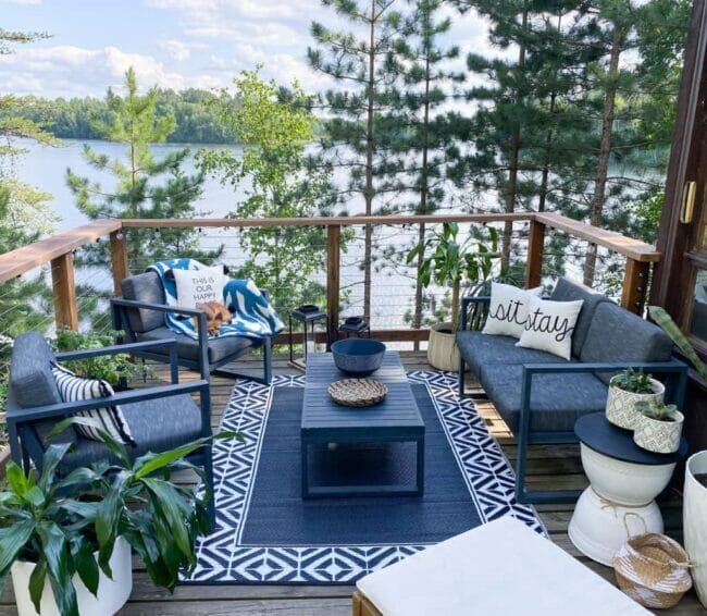 upper deck with lake view and blue rug and furniture