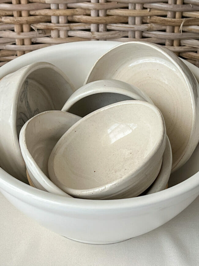 a white bowl full of small white bowls