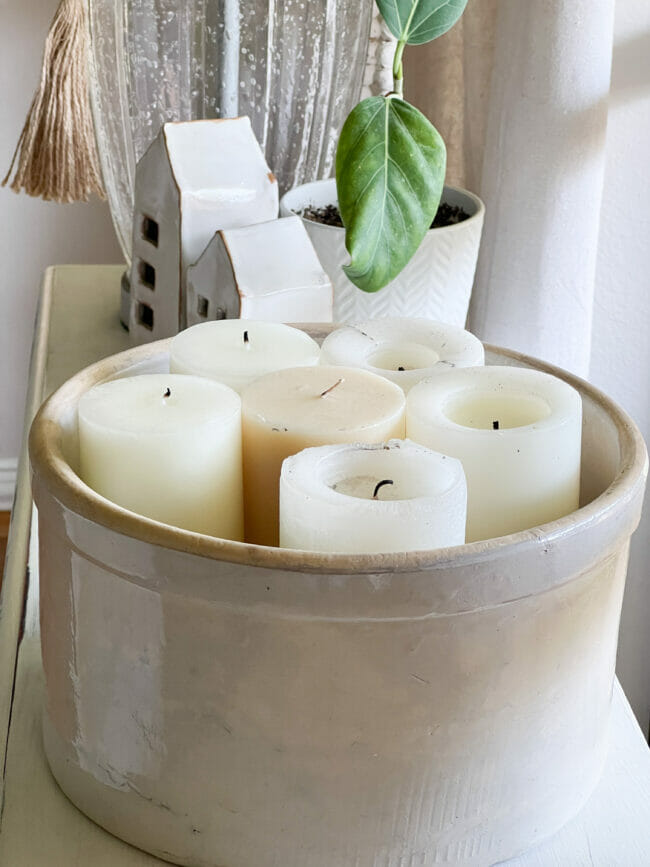 vintage crock full of white candles