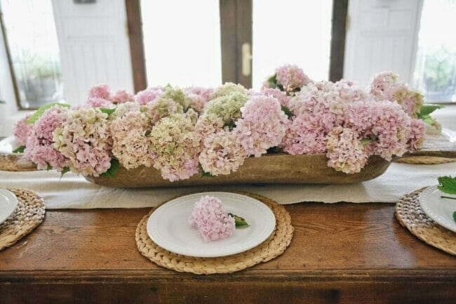 wooden bowl full of pink hydrangeas