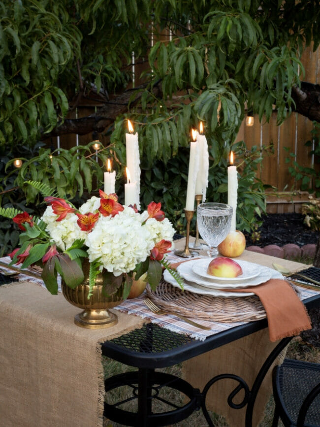 table with apples, candles and floral arrangement