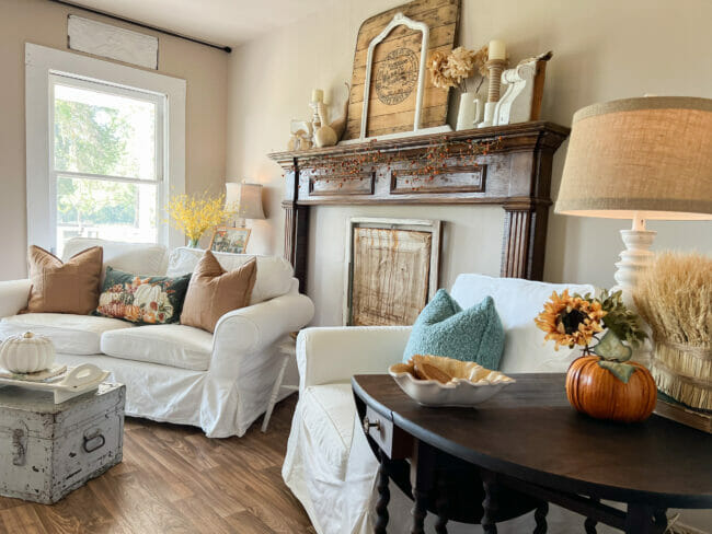 living room with fall decor and mantel