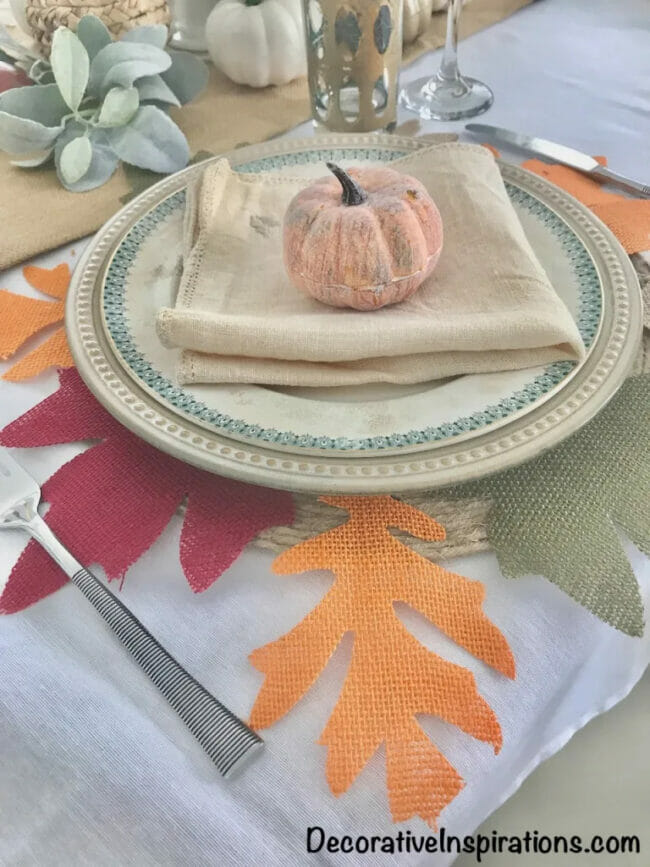 burlap and leaf placemat with pumpkin on plates