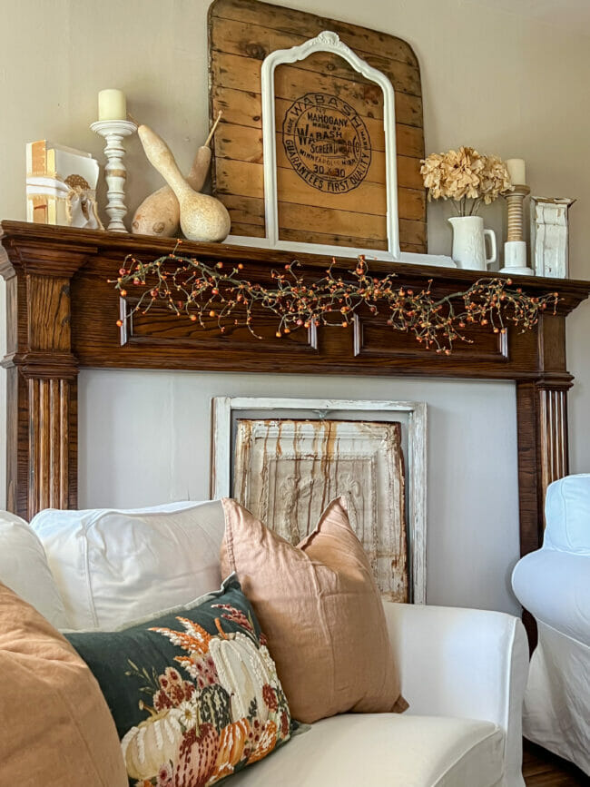 fall mantel with sofa and fall pillows