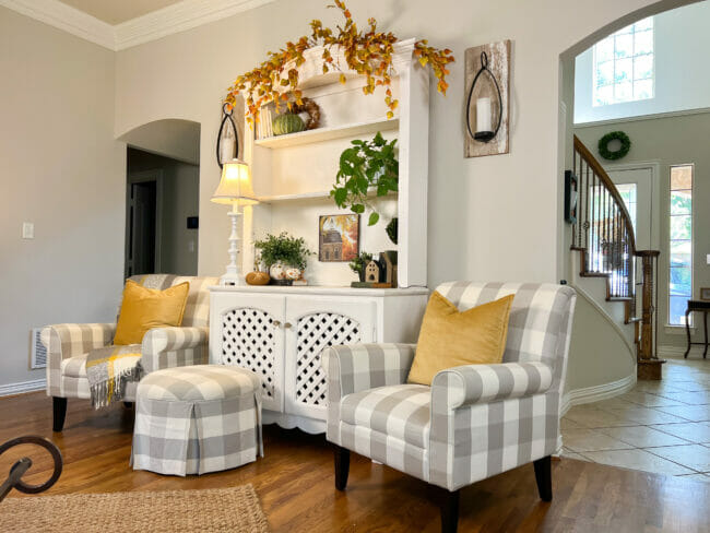 gray checked chairs with hutch decorated for fall