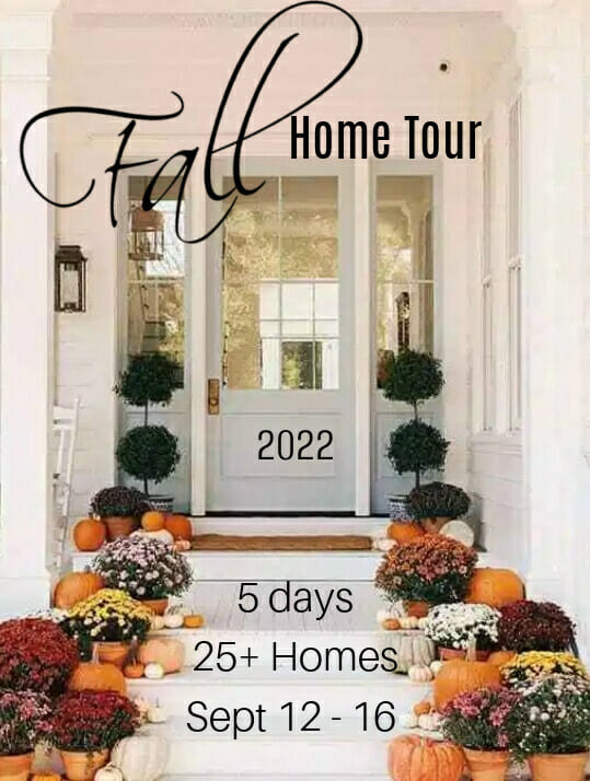 gray front door with pumpkins, mums and topiaries