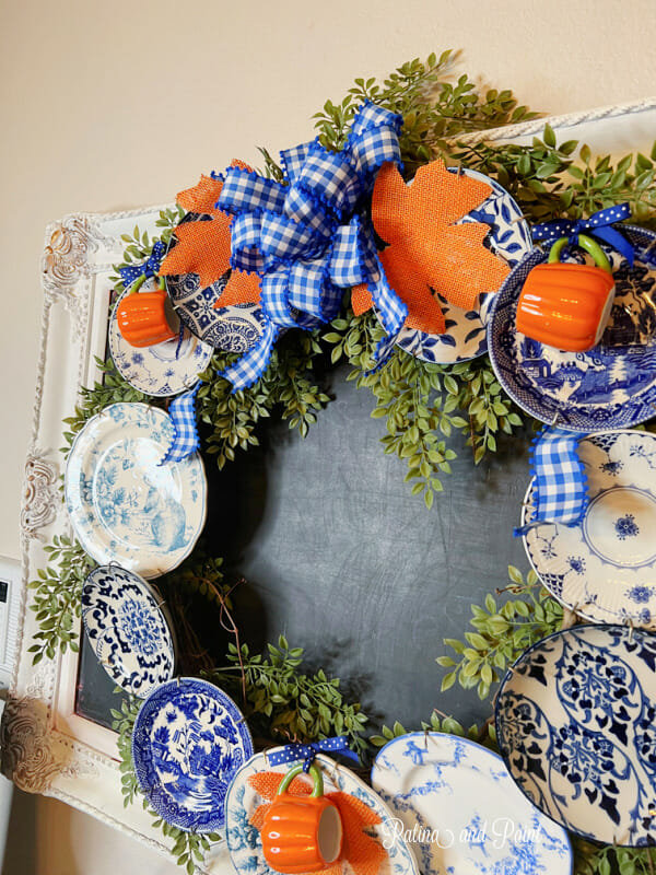 blue and white plate wreath with orange fall leaves and bow