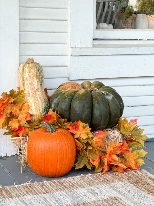vignette of pumpkins, gourds and fall garland