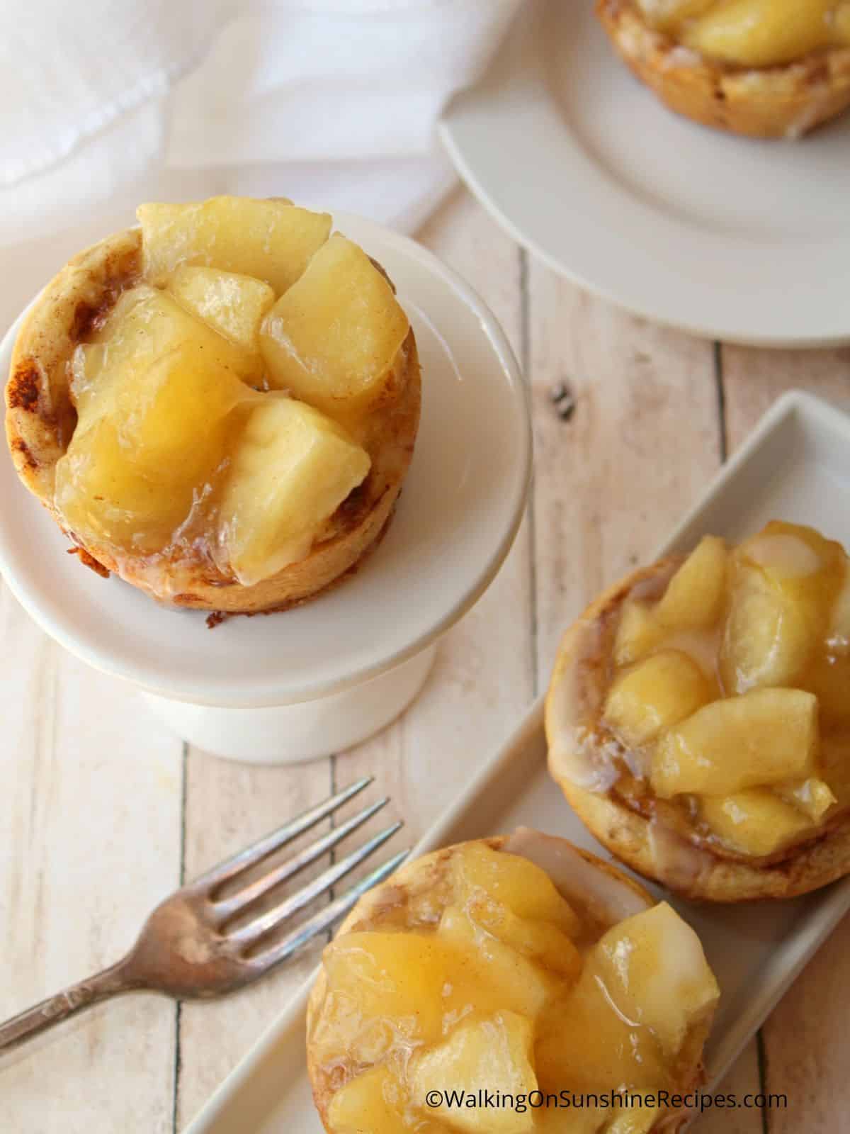 white platter with apple pies and a fork