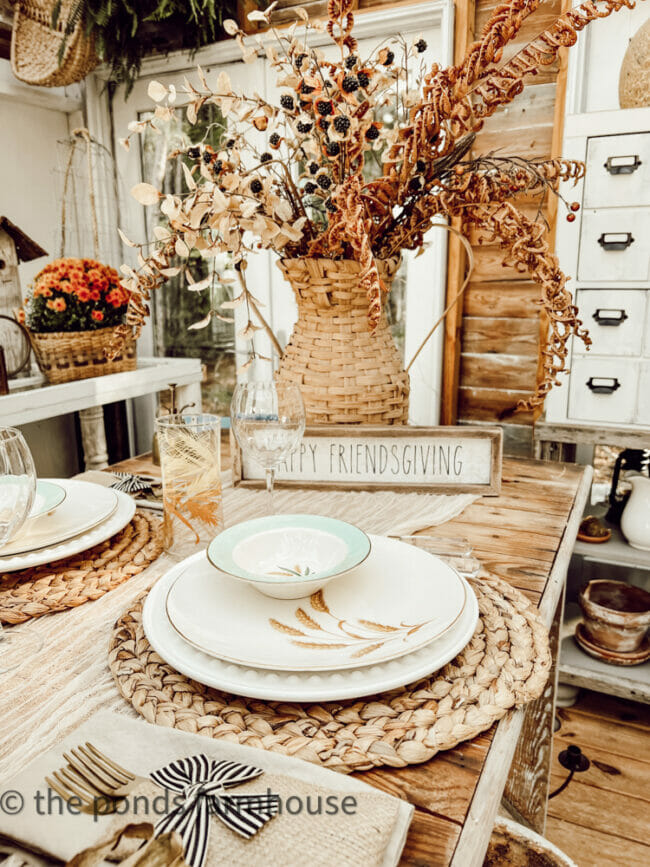 rattan place setting with vase of faux flowers