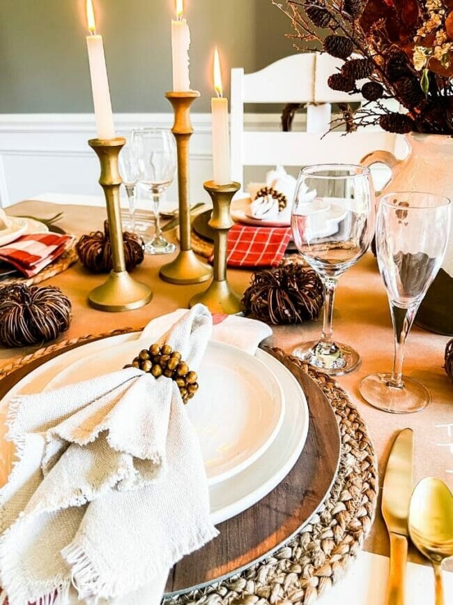 place setting with candles and napkin in ring