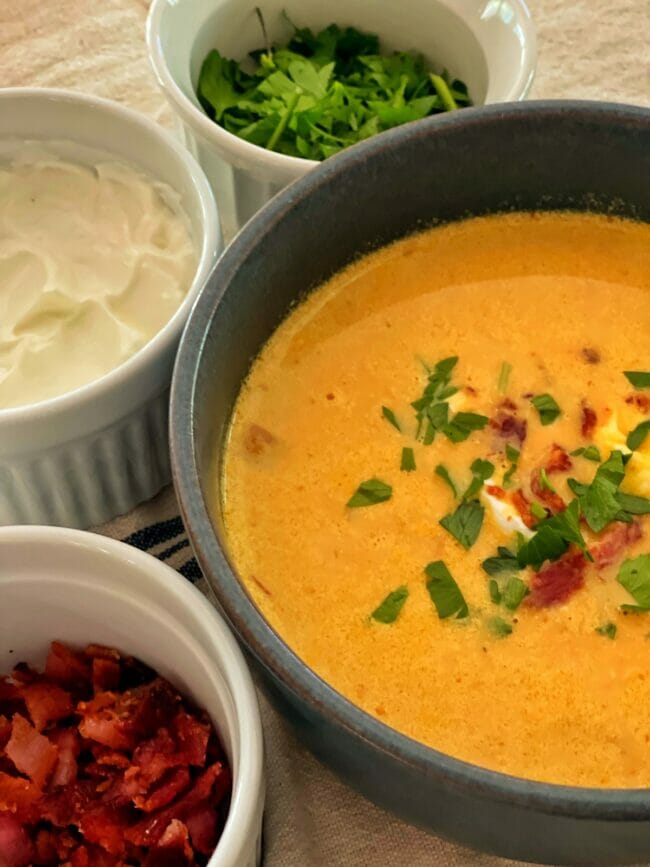 bowls of pumpkin soup and sides
