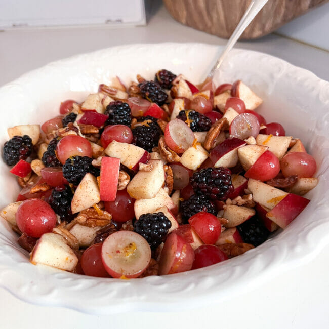 fall fruit salad in white bowl with spoon