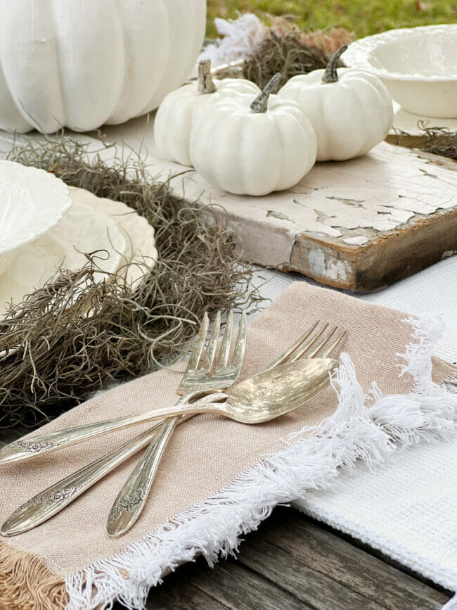 silverware on fringed napkin with pumpkins