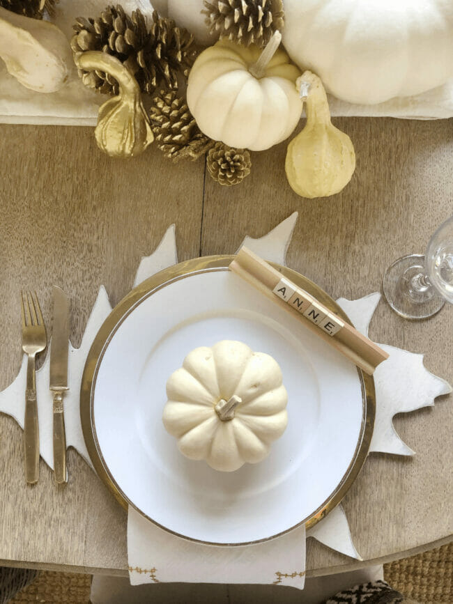 white plate with white pumpkin on leaf charger