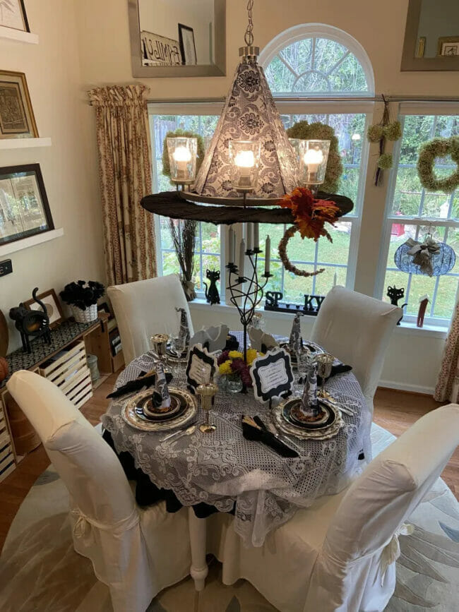 witch hat chandelier and Halloween table setting