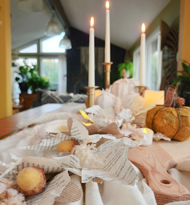 candles and book page garland for centerpiece on table