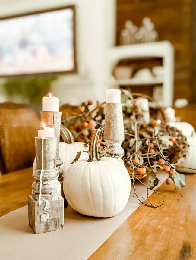 chippy candlesticks with white pumpkin and basket for fall centerpiece on table