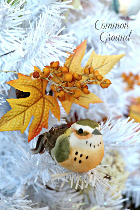 white tree with fall leaves and bird inside