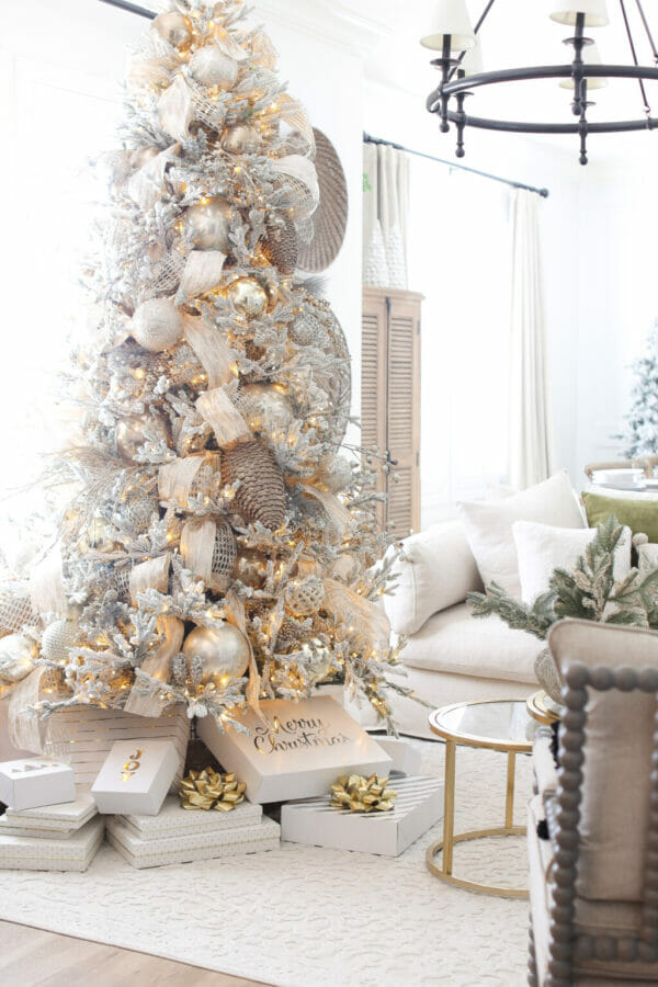 Gold and silver Christmas tree with gifts and white sofa