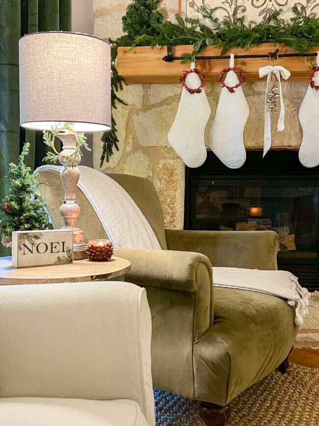 green velvet chair with white stockings on mantel